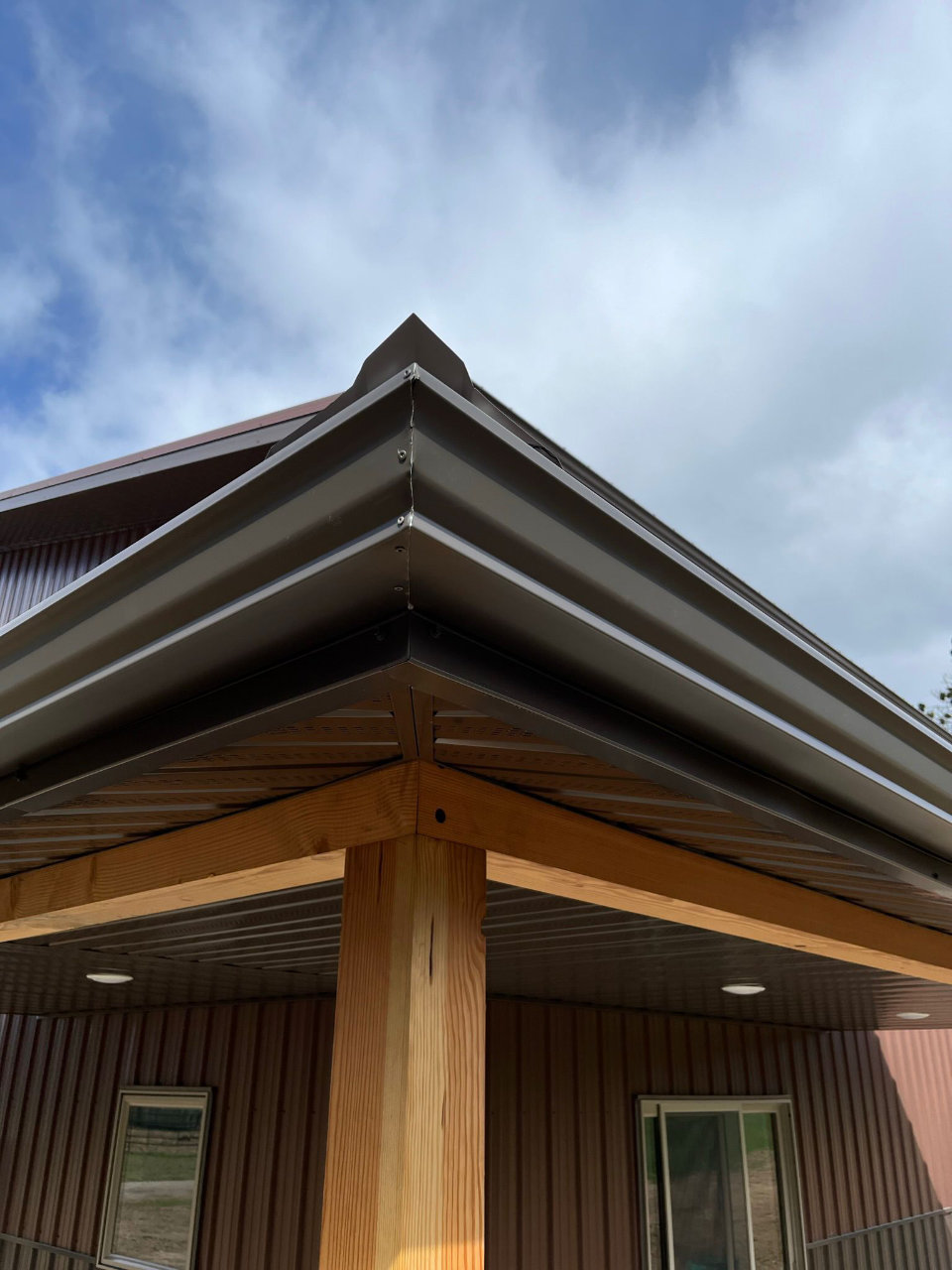 Roofline with seamless gutters where snow stops protect from sliding snow